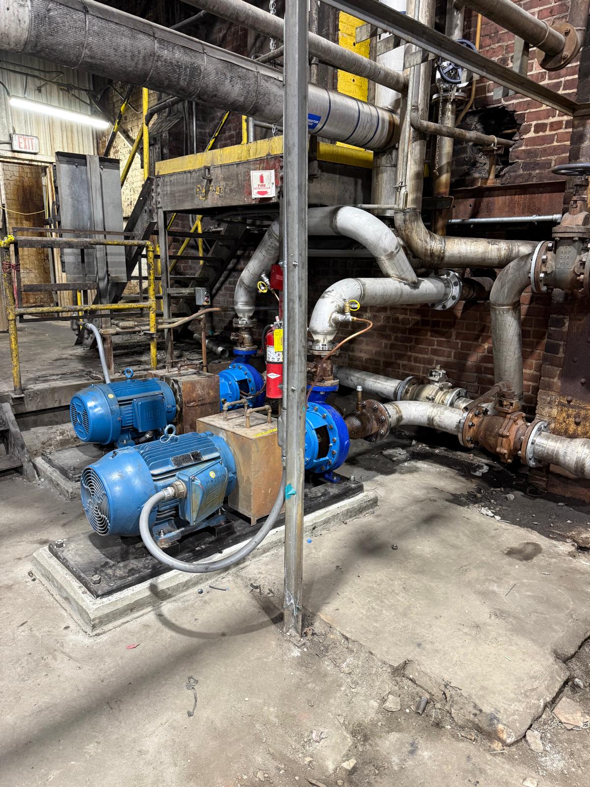 Completed pump station installation with stainless steel piping system